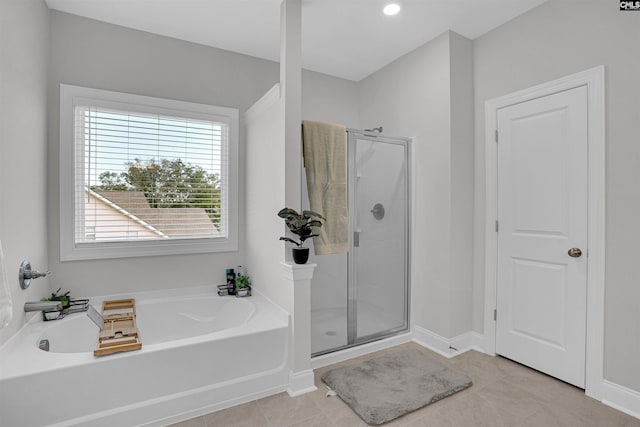 bathroom with tile patterned floors and shower with separate bathtub