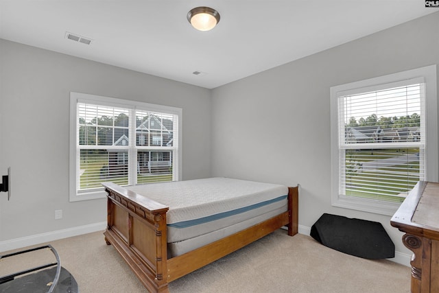 bedroom featuring light carpet