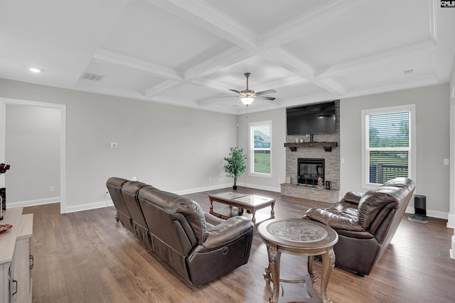 living room with coffered ceiling, beam ceiling, wood-type flooring, ceiling fan, and a fireplace