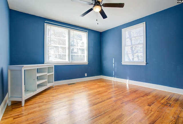 spare room featuring light hardwood / wood-style flooring and ceiling fan