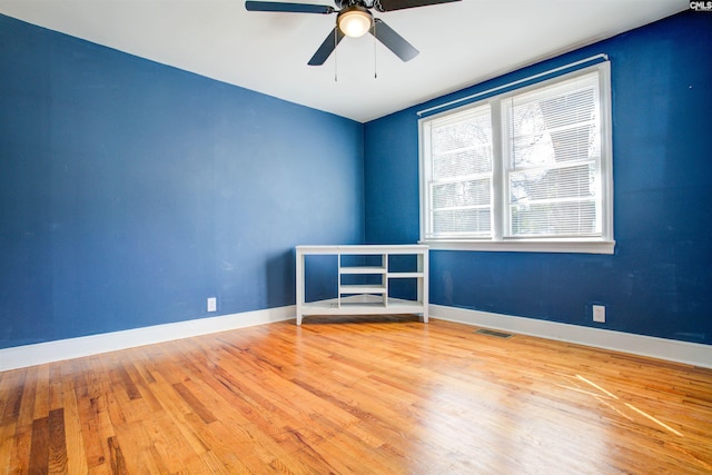 spare room with hardwood / wood-style floors and ceiling fan