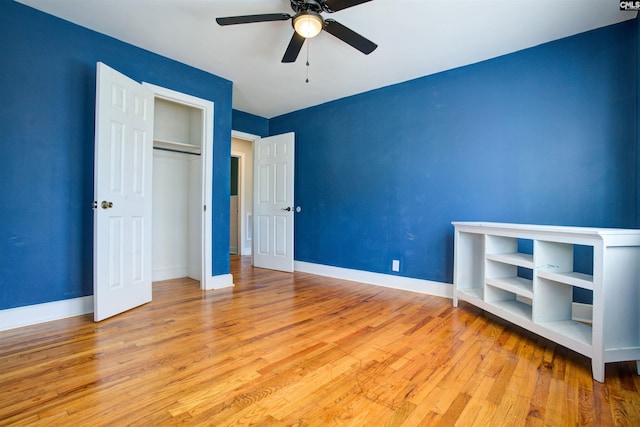 unfurnished bedroom with light hardwood / wood-style flooring, a closet, and ceiling fan