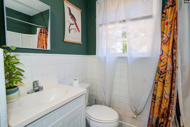 bathroom with vanity, tile walls, a shower with shower curtain, and toilet