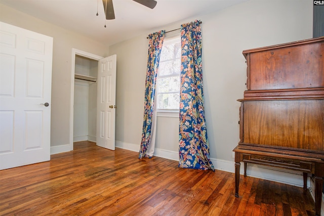 bedroom with dark hardwood / wood-style floors and ceiling fan