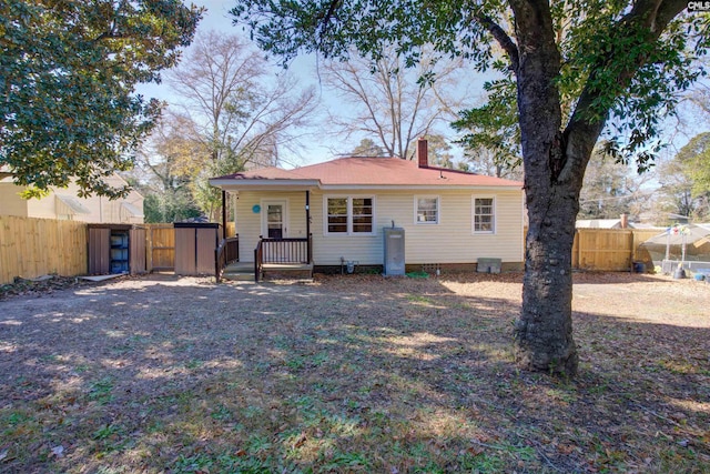 back of property featuring a storage unit