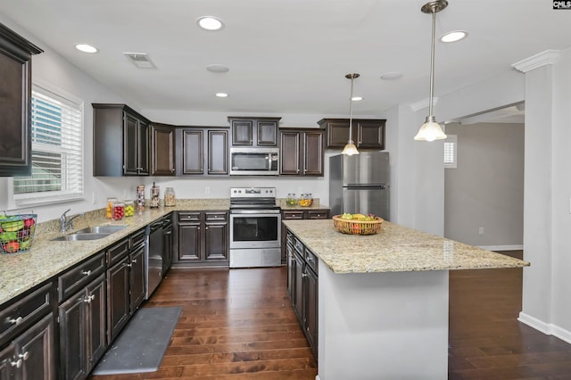 kitchen with pendant lighting, sink, dark hardwood / wood-style floors, and appliances with stainless steel finishes