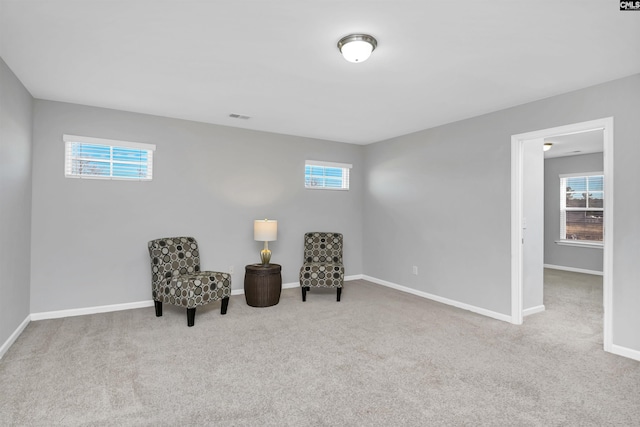 living area with light carpet