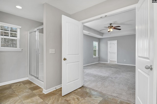 bathroom featuring an enclosed shower and ceiling fan