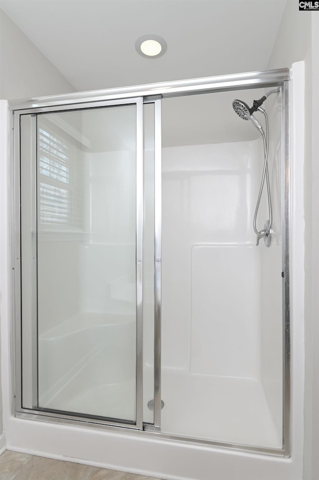 bathroom featuring an enclosed shower and tile patterned floors