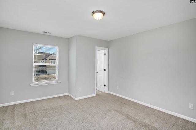 empty room featuring light carpet