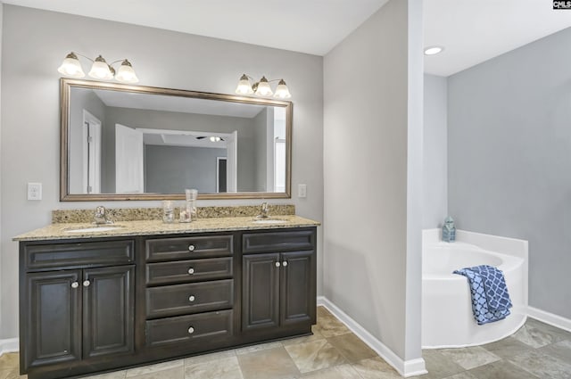 bathroom featuring vanity and a tub to relax in