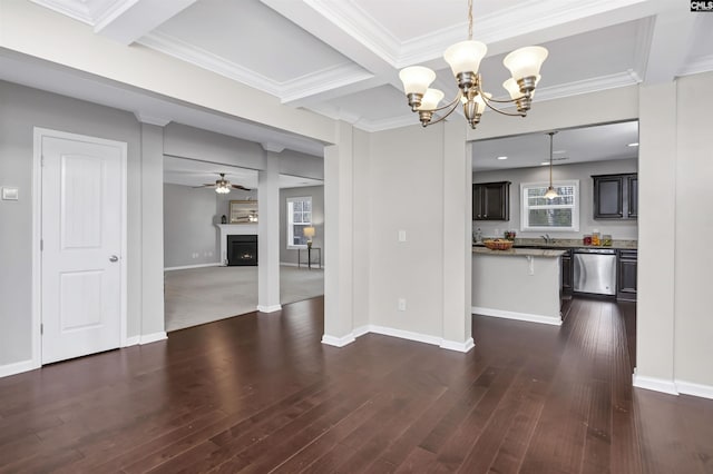 unfurnished dining area with crown molding, coffered ceiling, dark hardwood / wood-style flooring, ceiling fan with notable chandelier, and beamed ceiling