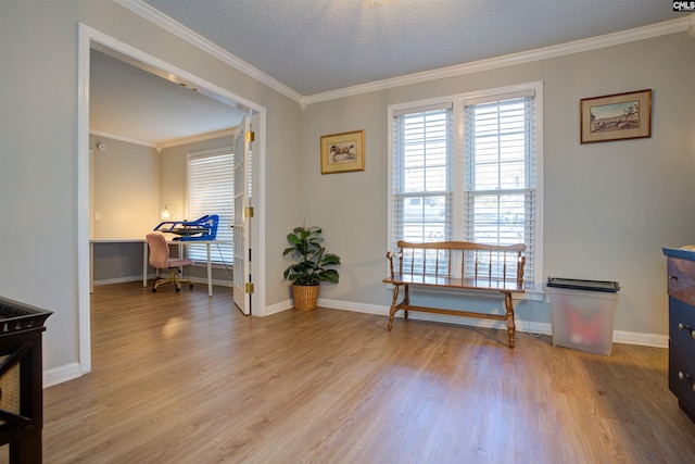 interior space featuring ornamental molding, light hardwood / wood-style floors, and a textured ceiling