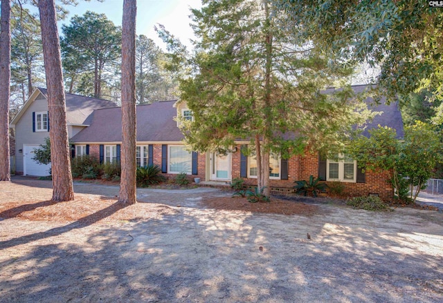 view of front of house with a garage and brick siding