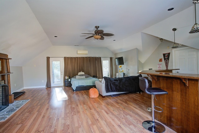 living room featuring bar, vaulted ceiling, a wealth of natural light, and light wood-type flooring