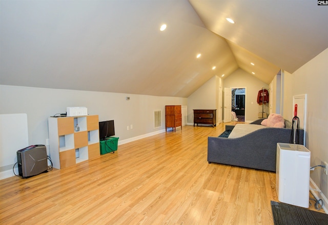 interior space with lofted ceiling and light hardwood / wood-style flooring