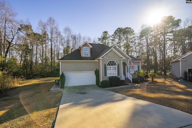 view of front of house with a garage and a front lawn