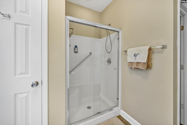 bathroom featuring a shower with shower door