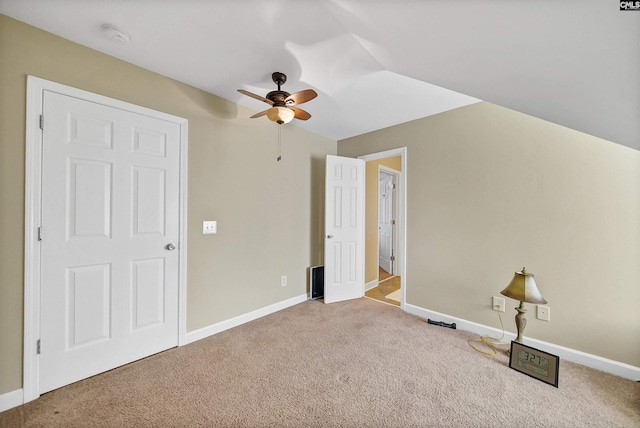 additional living space with light colored carpet and ceiling fan