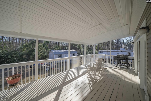 wooden terrace featuring a storage shed