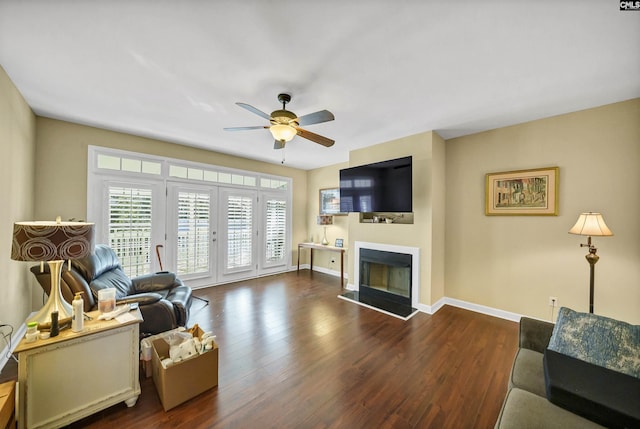 living room with dark hardwood / wood-style floors and ceiling fan