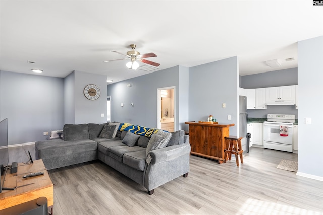 living room featuring light hardwood / wood-style floors and ceiling fan