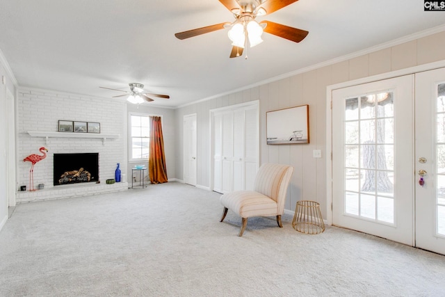 living area with french doors, carpet flooring, crown molding, and a brick fireplace