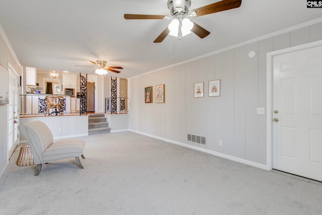 sitting room featuring crown molding, light colored carpet, and ceiling fan