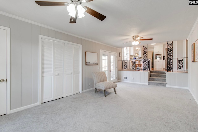 unfurnished room featuring french doors, ornamental molding, and light carpet