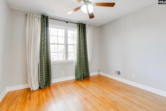 unfurnished room with wood-type flooring and ceiling fan