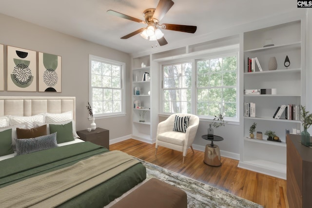 bedroom with ceiling fan and light hardwood / wood-style flooring