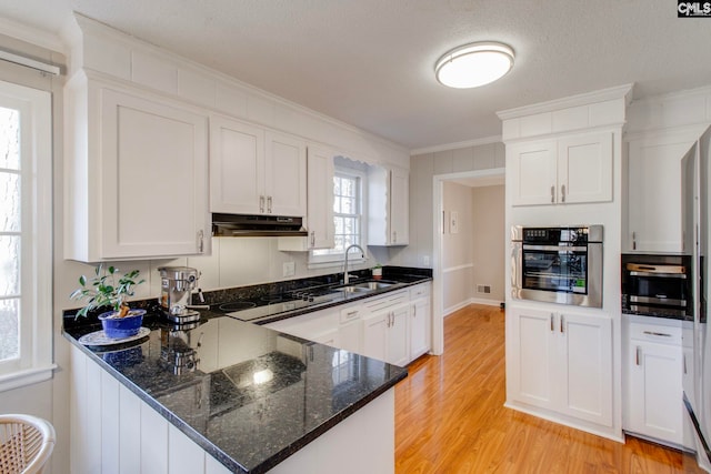 kitchen with white cabinets and stainless steel oven