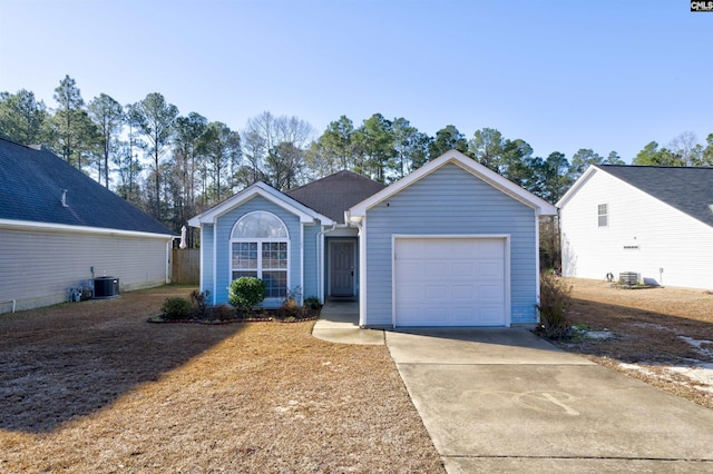 single story home featuring central AC and a garage