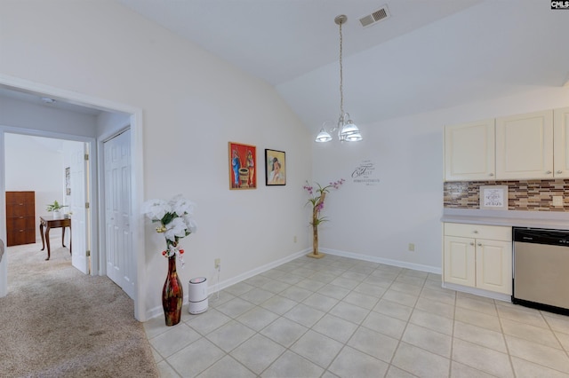 kitchen featuring pendant lighting, tasteful backsplash, dishwasher, lofted ceiling, and a notable chandelier