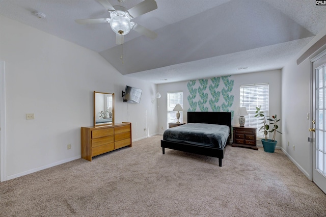 carpeted bedroom featuring multiple windows, vaulted ceiling, a textured ceiling, and ceiling fan