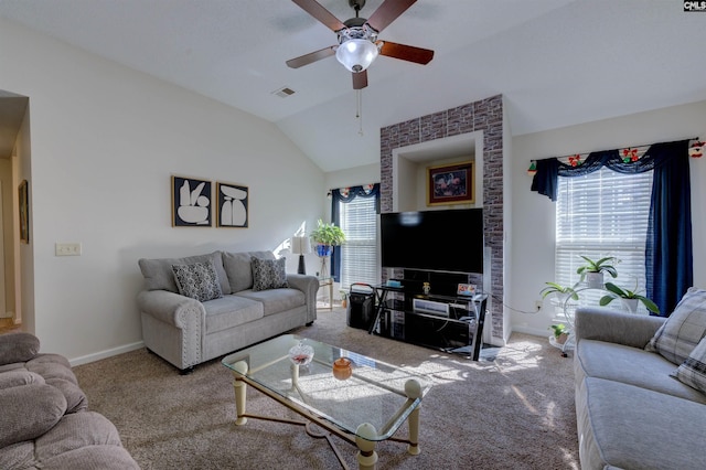 carpeted living room with ceiling fan, lofted ceiling, and plenty of natural light