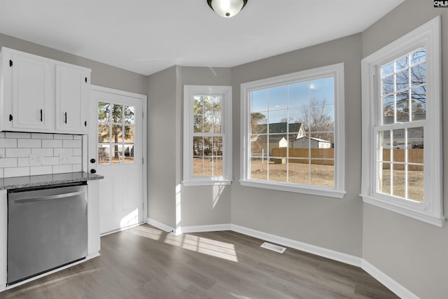 unfurnished dining area with wood-type flooring