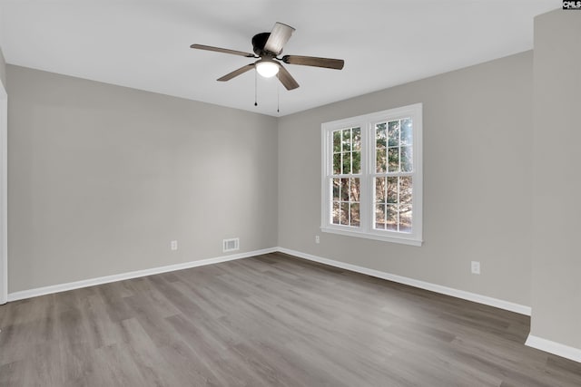 empty room featuring wood-type flooring and ceiling fan