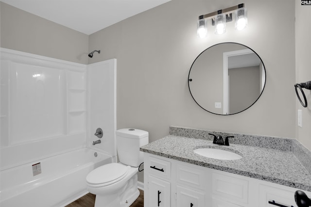 full bathroom with hardwood / wood-style flooring, vanity, toilet, and shower / bathing tub combination