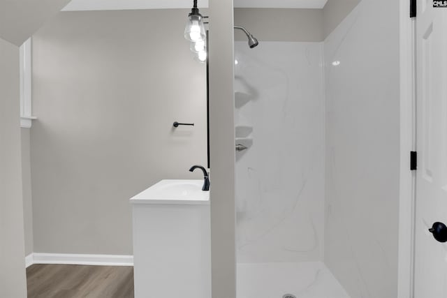 bathroom featuring vanity, hardwood / wood-style flooring, and walk in shower