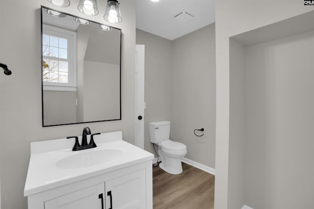 bathroom featuring hardwood / wood-style flooring, vanity, and toilet