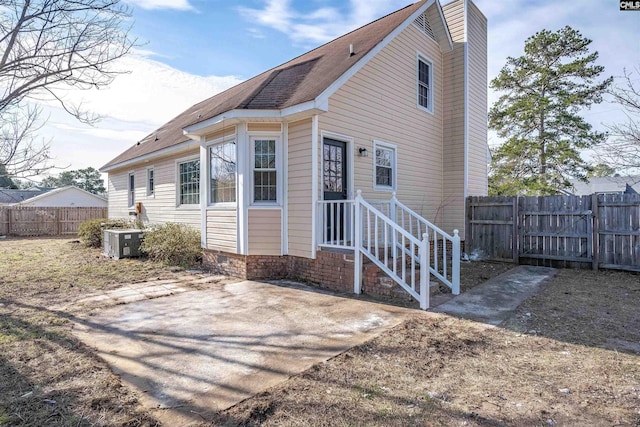 back of house featuring cooling unit and a patio