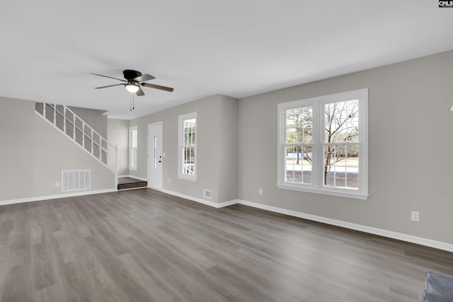 unfurnished living room featuring hardwood / wood-style flooring, ceiling fan, and plenty of natural light