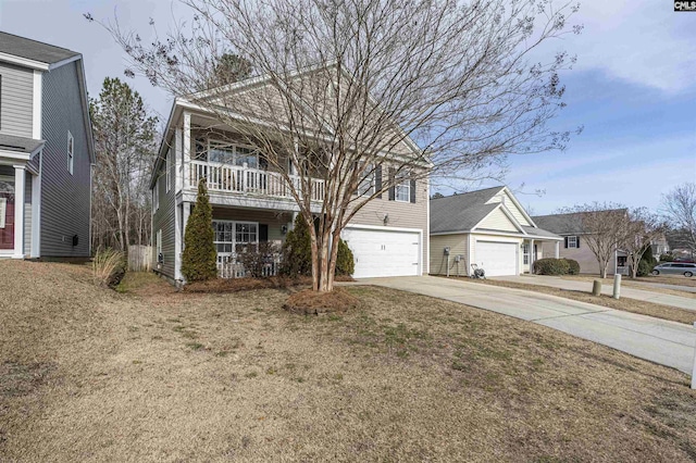 view of front property featuring a balcony, a garage, and a front yard