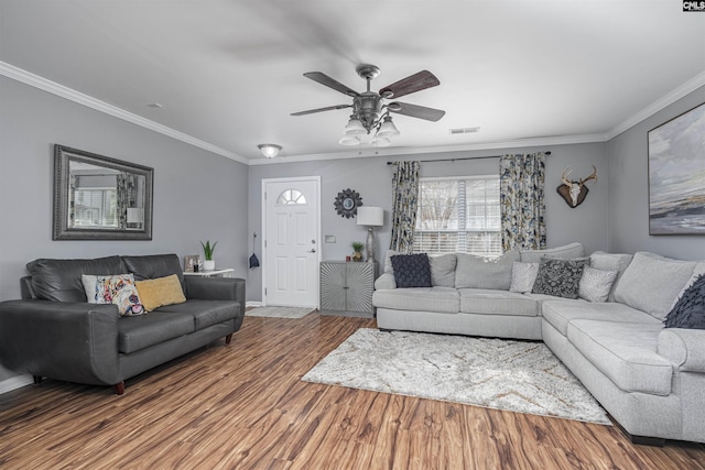 living room featuring hardwood / wood-style flooring, ornamental molding, and ceiling fan