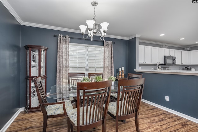 dining area featuring a notable chandelier, crown molding, and dark hardwood / wood-style floors