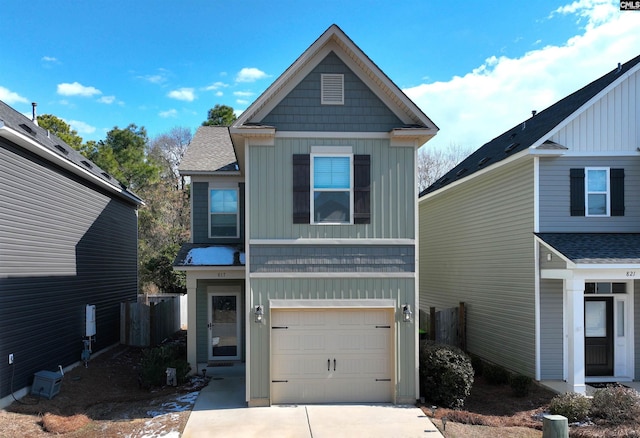 view of front facade with board and batten siding, concrete driveway, an attached garage, and a shingled roof