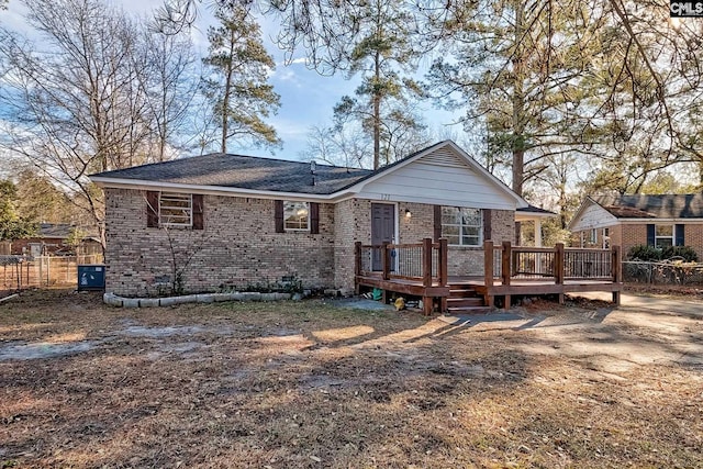 rear view of property featuring a deck