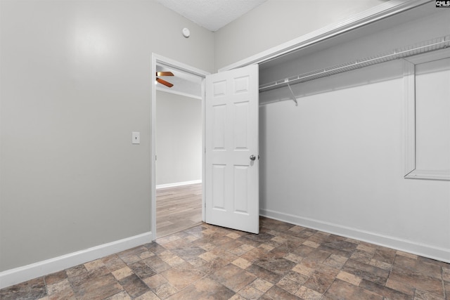 unfurnished bedroom with a closet and a textured ceiling