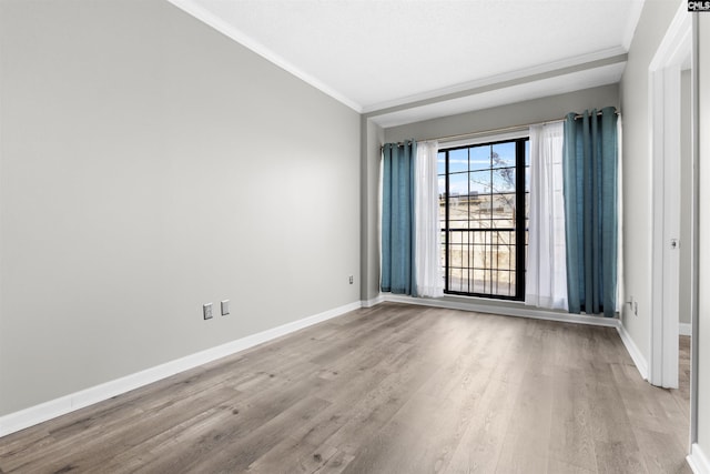 spare room featuring crown molding and light hardwood / wood-style flooring